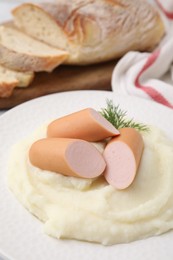 Photo of Delicious boiled sausages and mashed potato on table, closeup