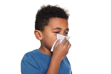 Photo of African-American boy blowing nose in tissue on white background. Cold symptoms