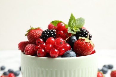 Photo of Mix of ripe berries in bowl, closeup