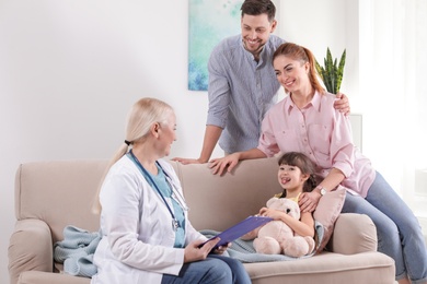 Photo of Family doctor visiting ill child at home