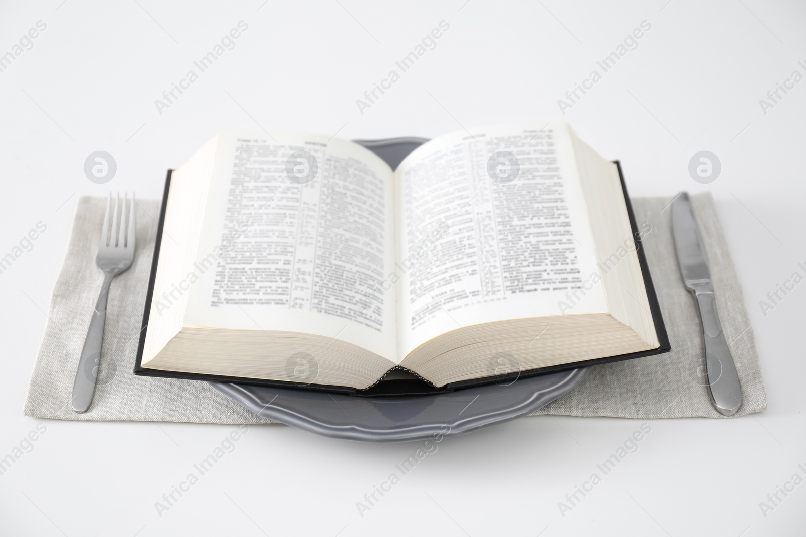 Photo of Table setting with Holy Bible on white background. Great Lent season