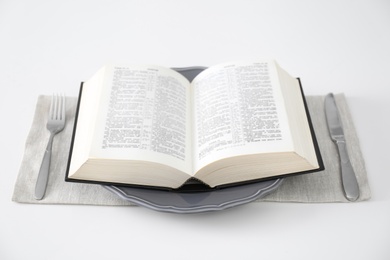 Photo of Table setting with Holy Bible on white background. Great Lent season
