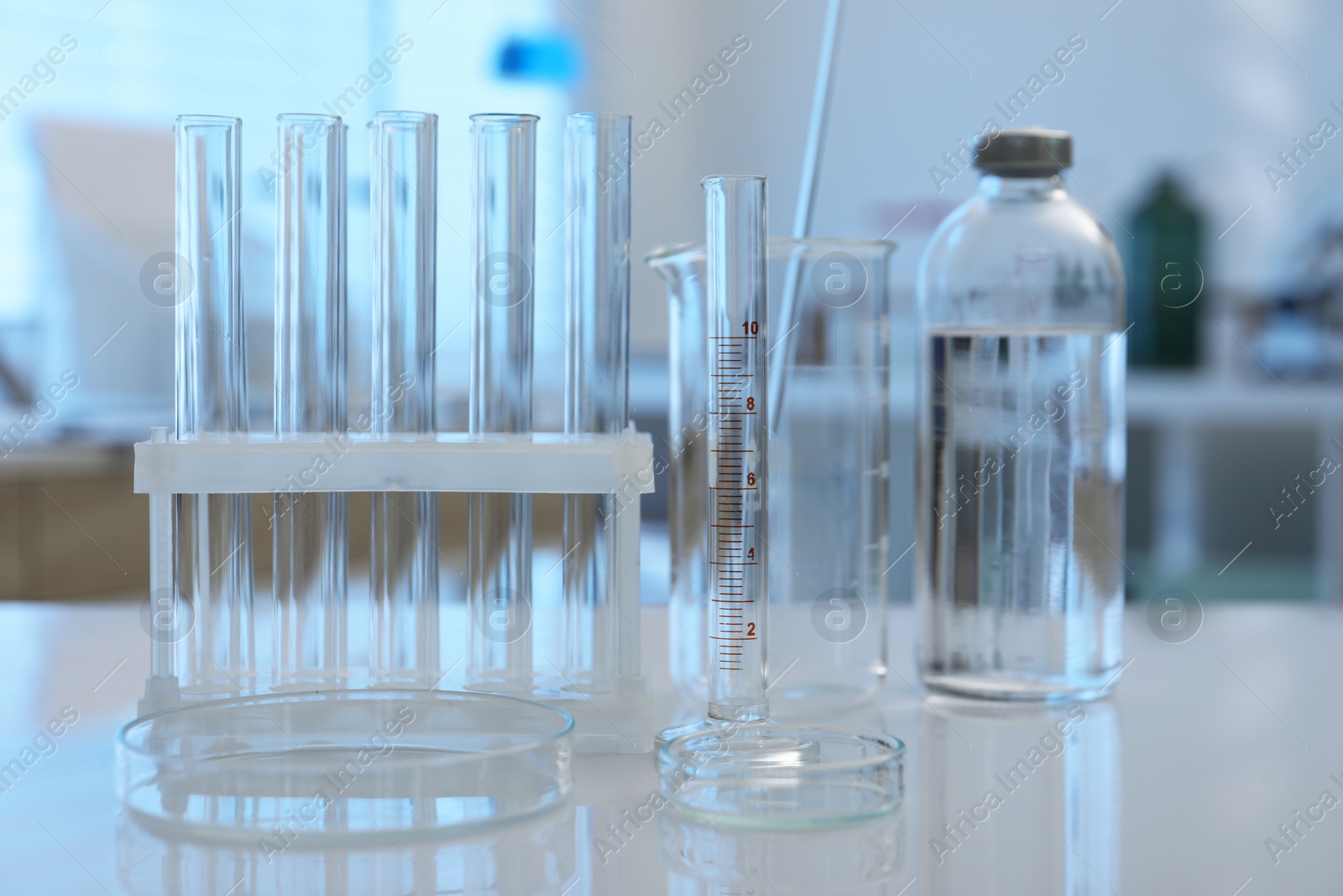 Photo of Laboratory analysis. Different glassware on white table indoors