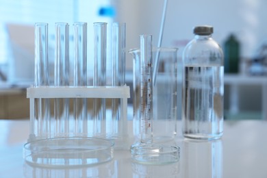 Laboratory analysis. Different glassware on white table indoors