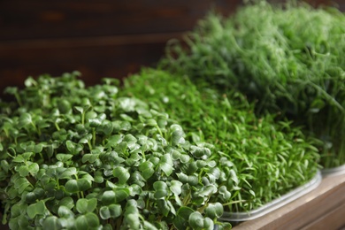 Photo of Fresh organic microgreens in wooden crate, closeup