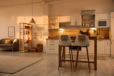 Photo of Modern kitchen interior with stylish wooden table