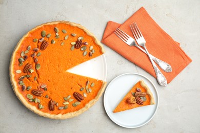 Photo of Delicious homemade pumpkin pie on light table, flat lay