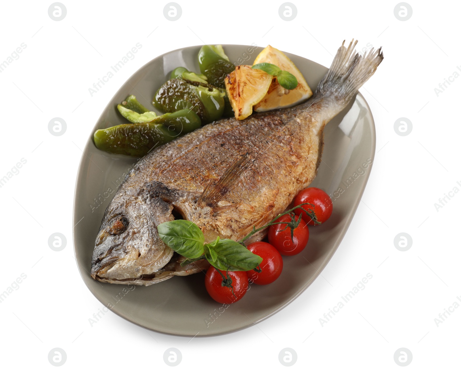 Photo of Delicious roasted dorado fish, vegetables, and lemon isolated on white, above view