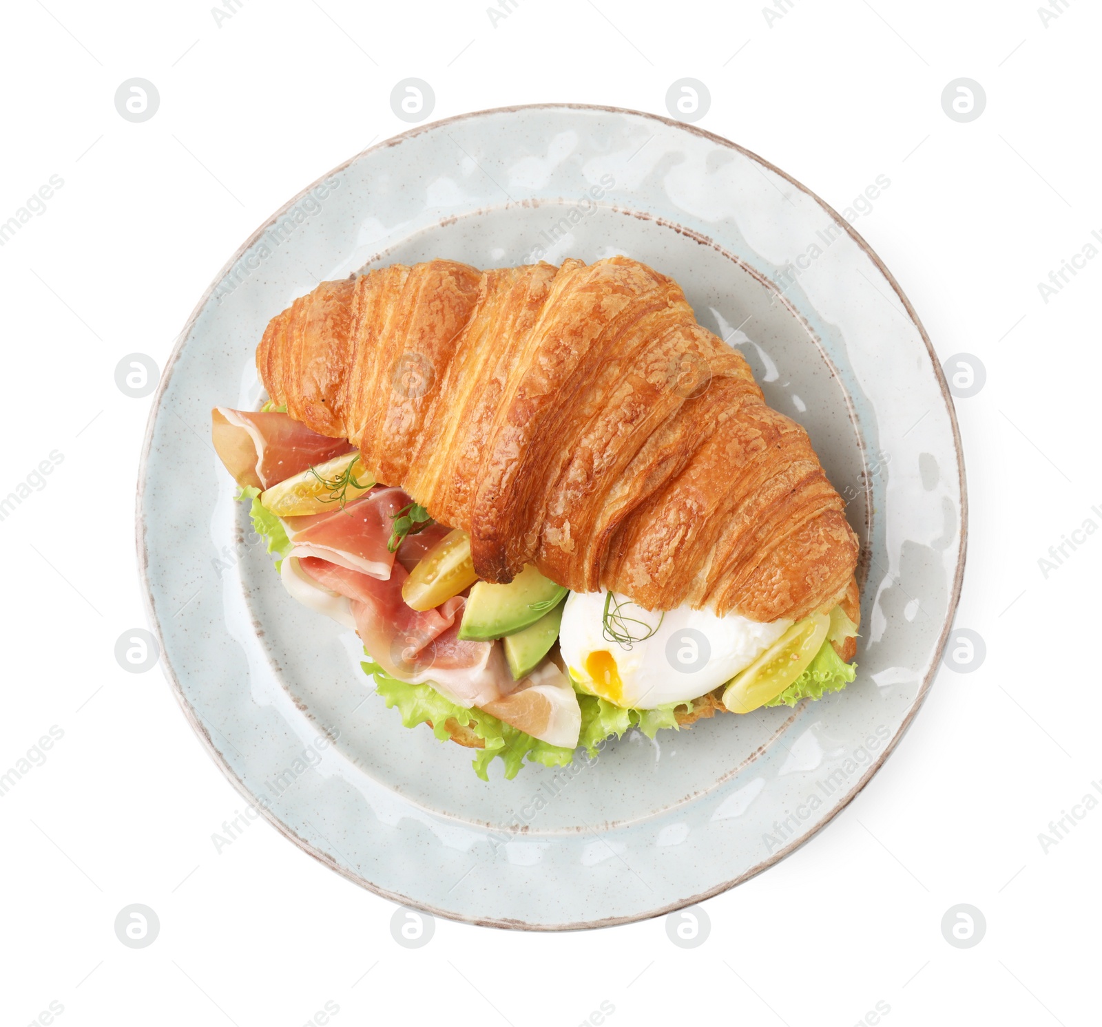 Photo of Delicious croissant with prosciutto, avocado and egg isolated on white, top view