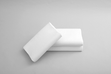 Photo of Clean soft orthopedic pillows on grey background