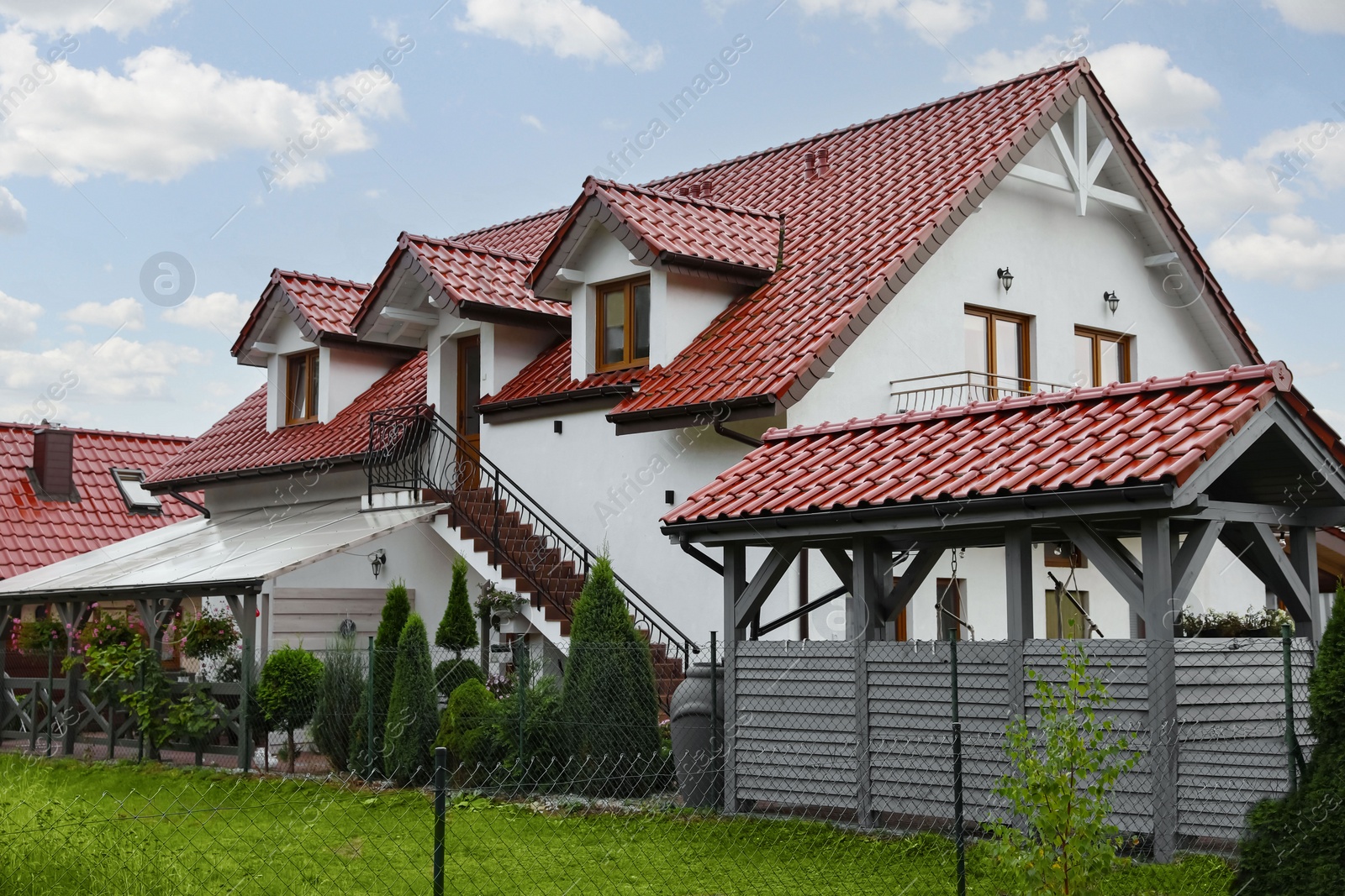 Photo of Beautiful two storey beach house and green trees outdoors