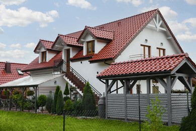 Photo of Beautiful two storey beach house and green trees outdoors