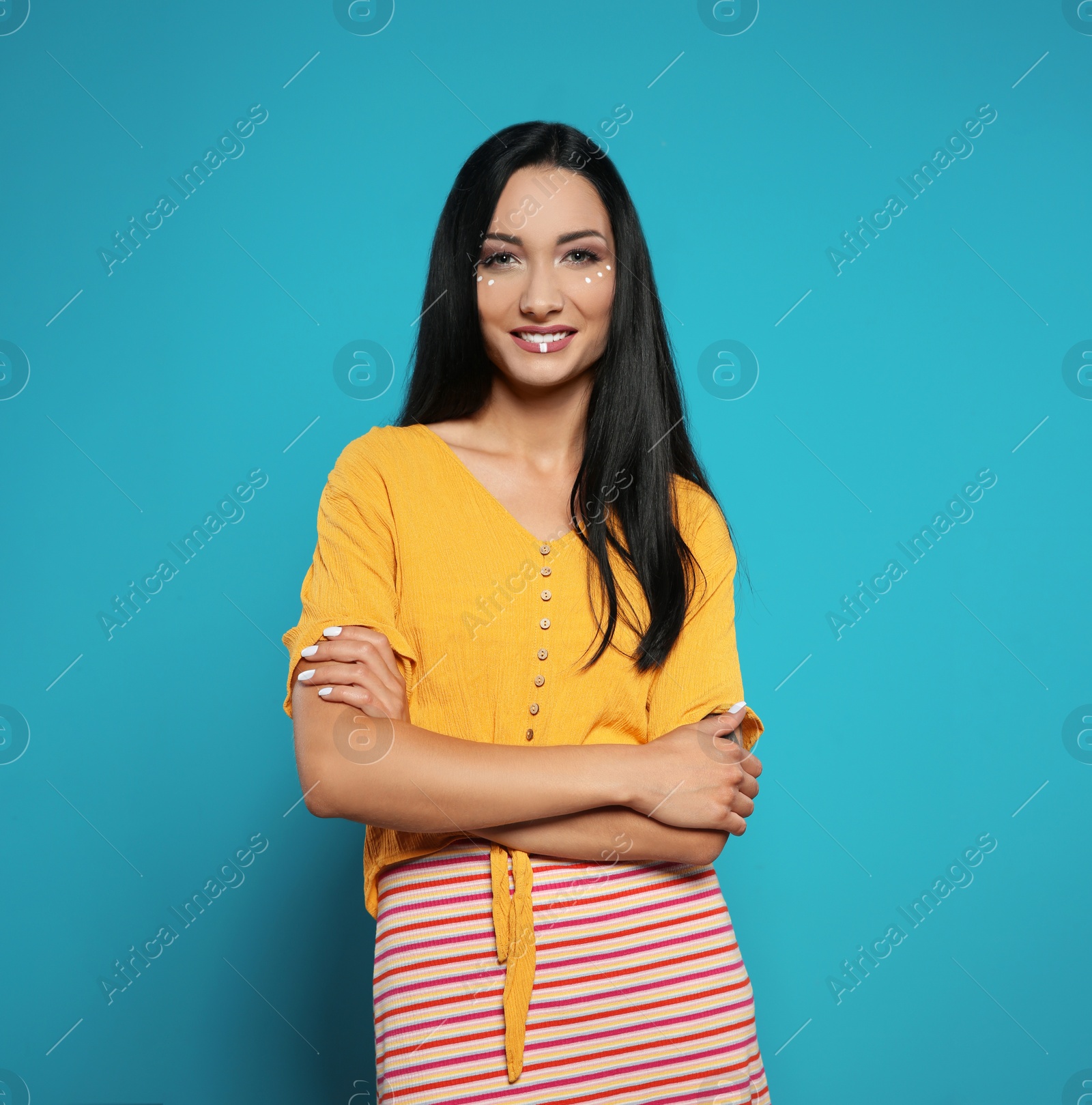 Photo of Portrait of young hippie woman with boho makeup in stylish outfit on color background