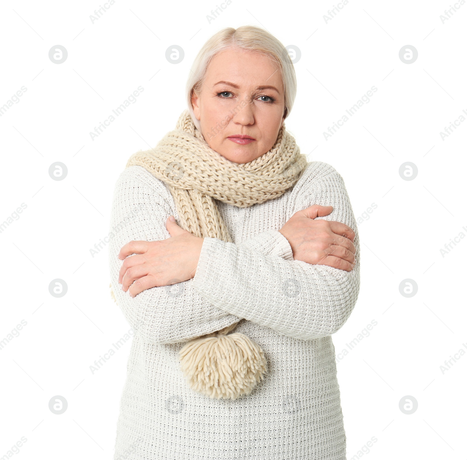 Photo of Mature woman in warm clothes suffering from cold on white background