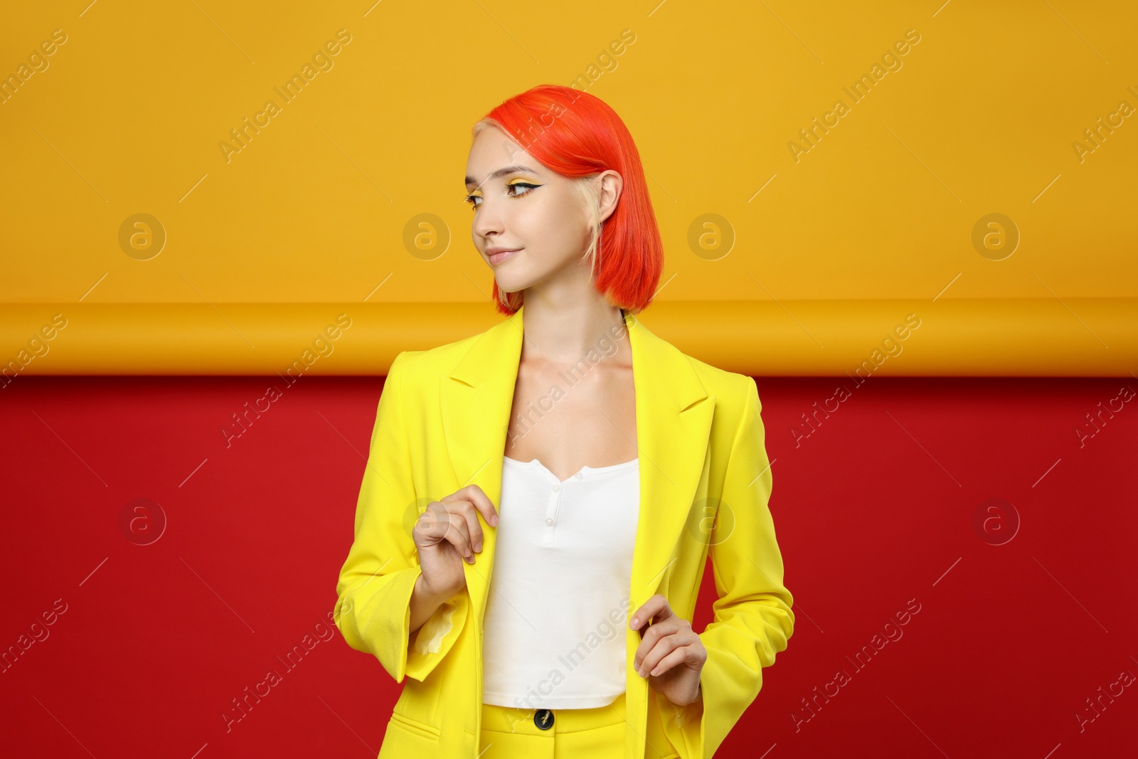 Photo of Beautiful young woman with bright dyed hair on color background