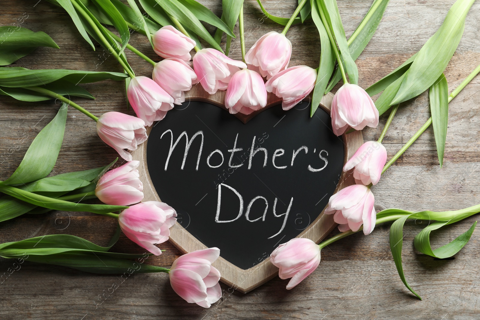 Photo of Chalkboard with text MOTHER'S DAY and tulips on wooden background, top view