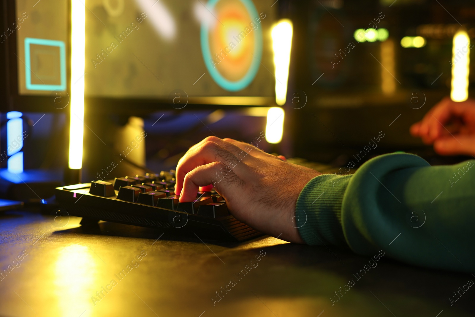 Photo of Man playing video games on computer at table, closeup