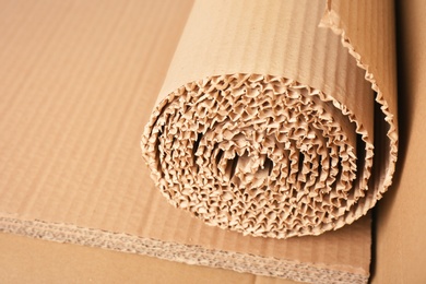 Roll of brown corrugated cardboard, closeup. Recyclable material