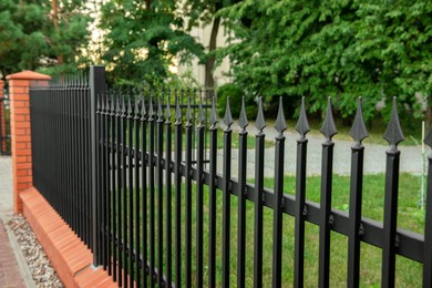 Beautiful brick fence with iron railing outdoors