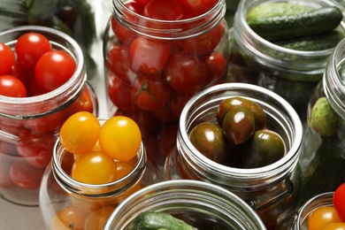 Pickling jars with fresh vegetables, closeup view