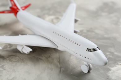 Photo of Toy airplane on grey background, closeup view