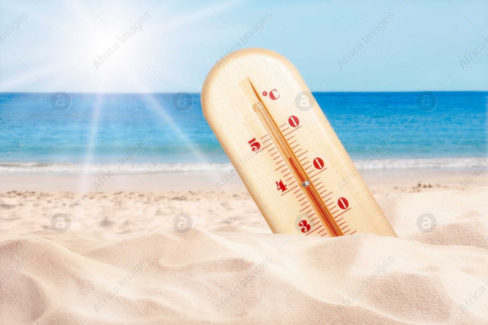 Image of Weather thermometer with high temperature on sandy beach near sea