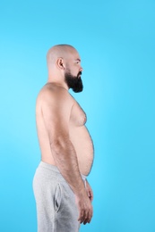 Photo of Fat man on color background. Weight loss