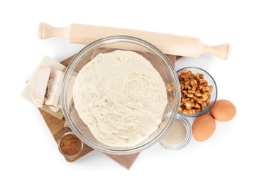 Fresh yeast dough and ingredients for cake on white background, top view