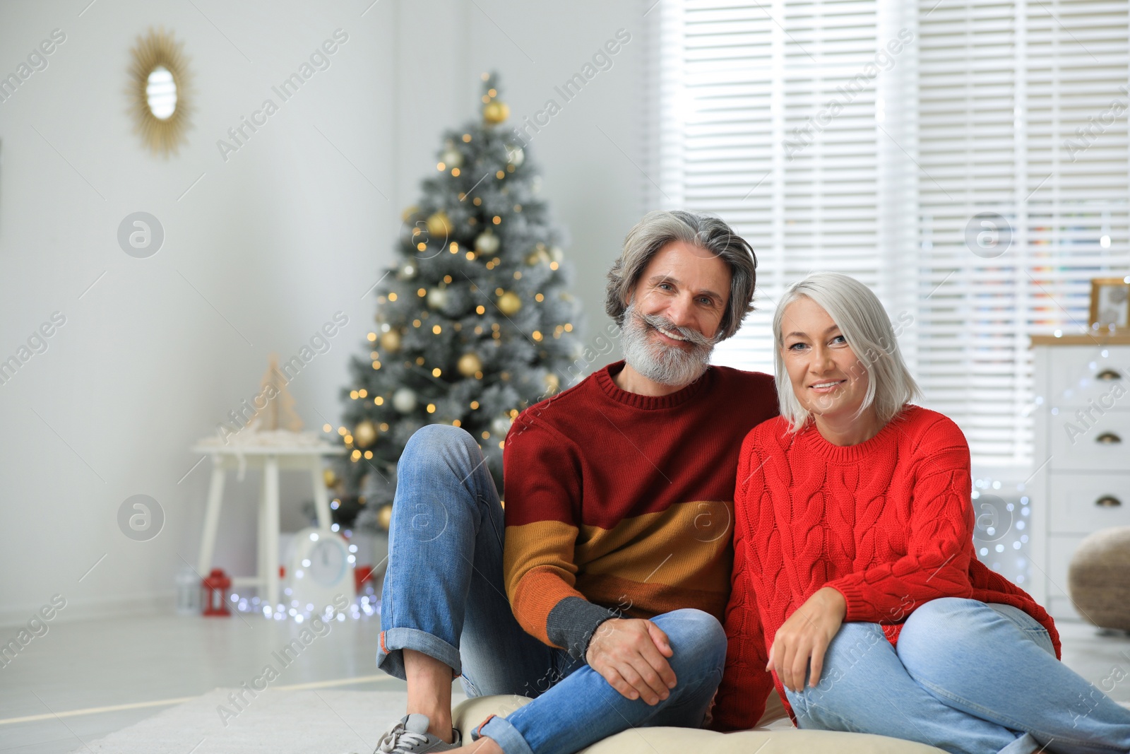 Photo of Happy mature couple celebrating Christmas at home