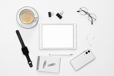 Photo of Flat lay composition with modern tablet on white background. Space for text