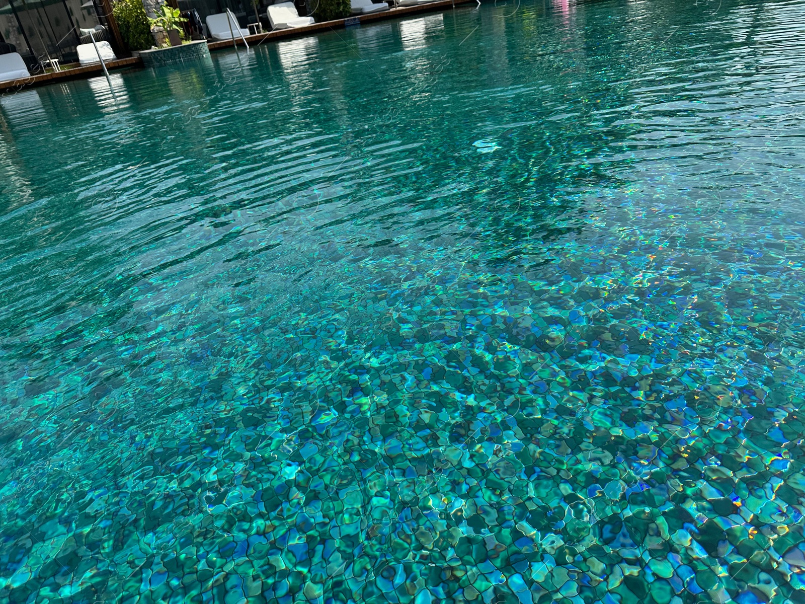 Photo of Clear rippled water in swimming pool outdoors