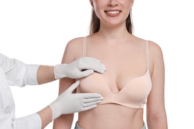 Photo of Mammologist checking woman's breast on white background, closeup