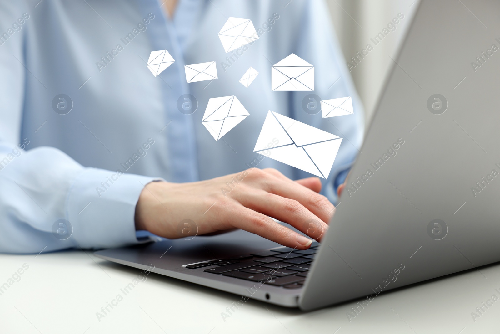 Image of Email. Woman using laptop at table, closeup. Letter illustrations over device