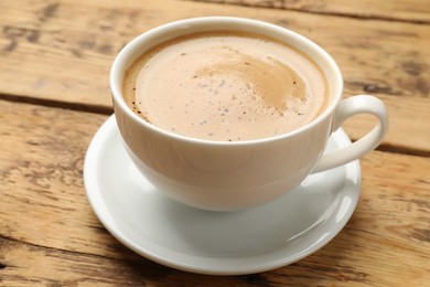 Photo of Cup of aromatic coffee on wooden table, closeup