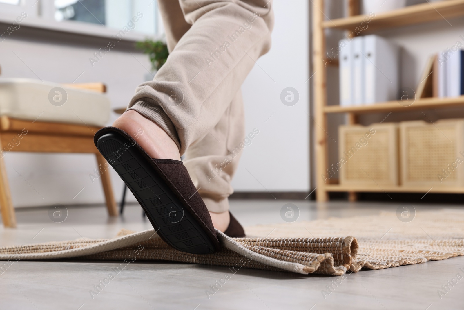 Photo of Man tripping over rug at home, closeup. Space for text