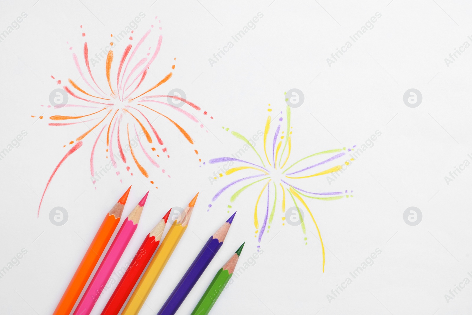 Photo of Abstract drawing and colorful pencils on white background, top view