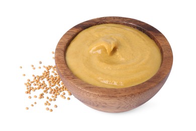 Fresh tasty mustard sauce in bowl and dry seeds isolated on white