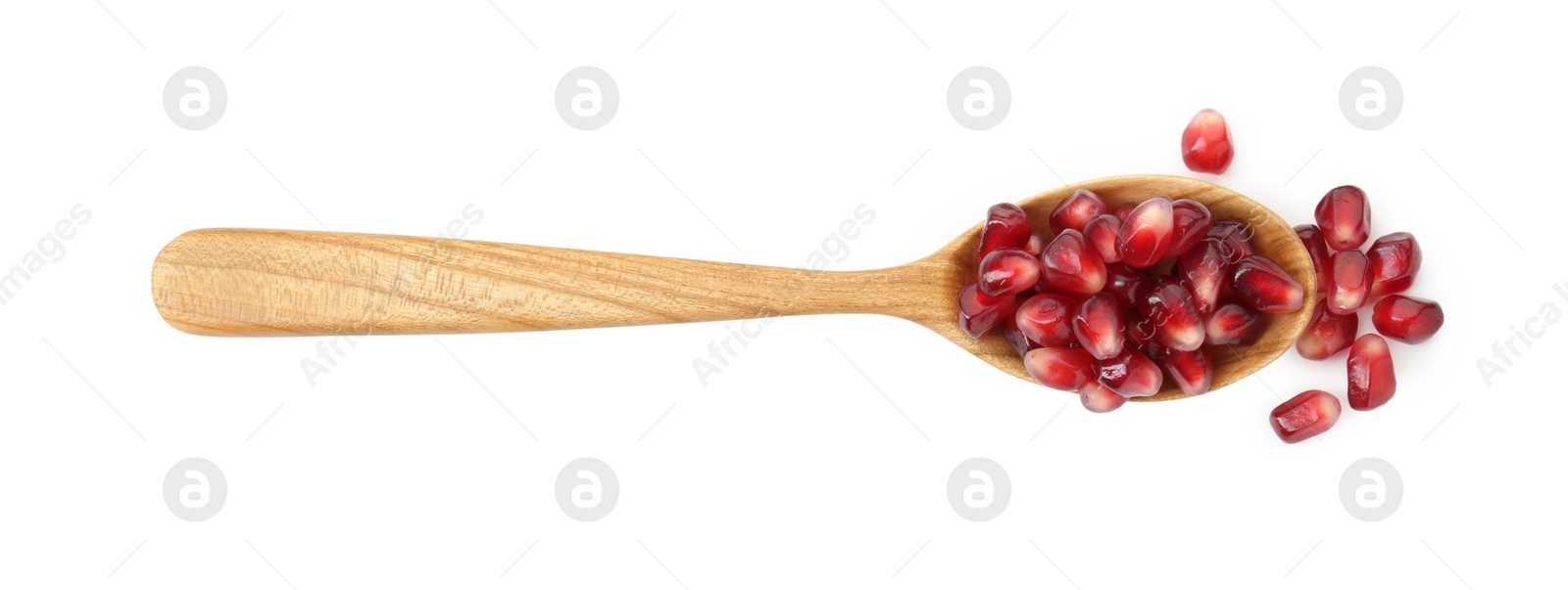 Photo of Ripe juicy pomegranate grains in wooden spoon isolated on white, top view