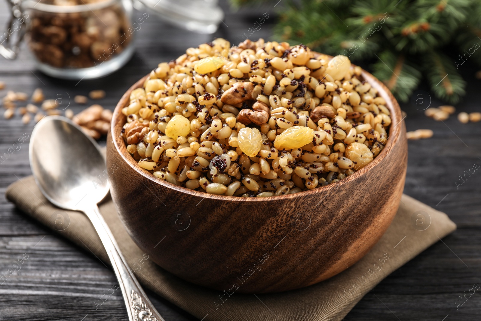 Photo of Traditional Christmas slavic dish kutia on black wooden table, closeup