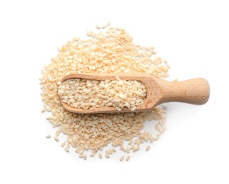 Photo of Wooden scoop with sesame seeds on white background, top view
