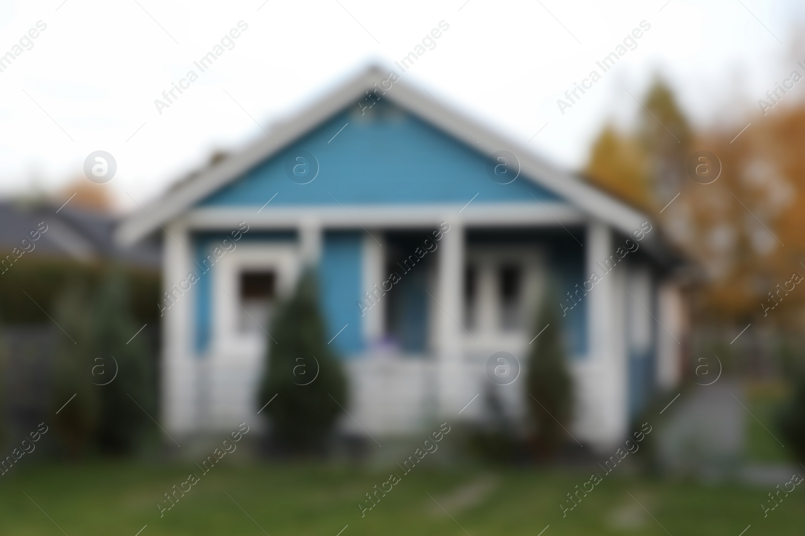 Photo of Blurred view of beautiful light blue house outdoors. Real estate