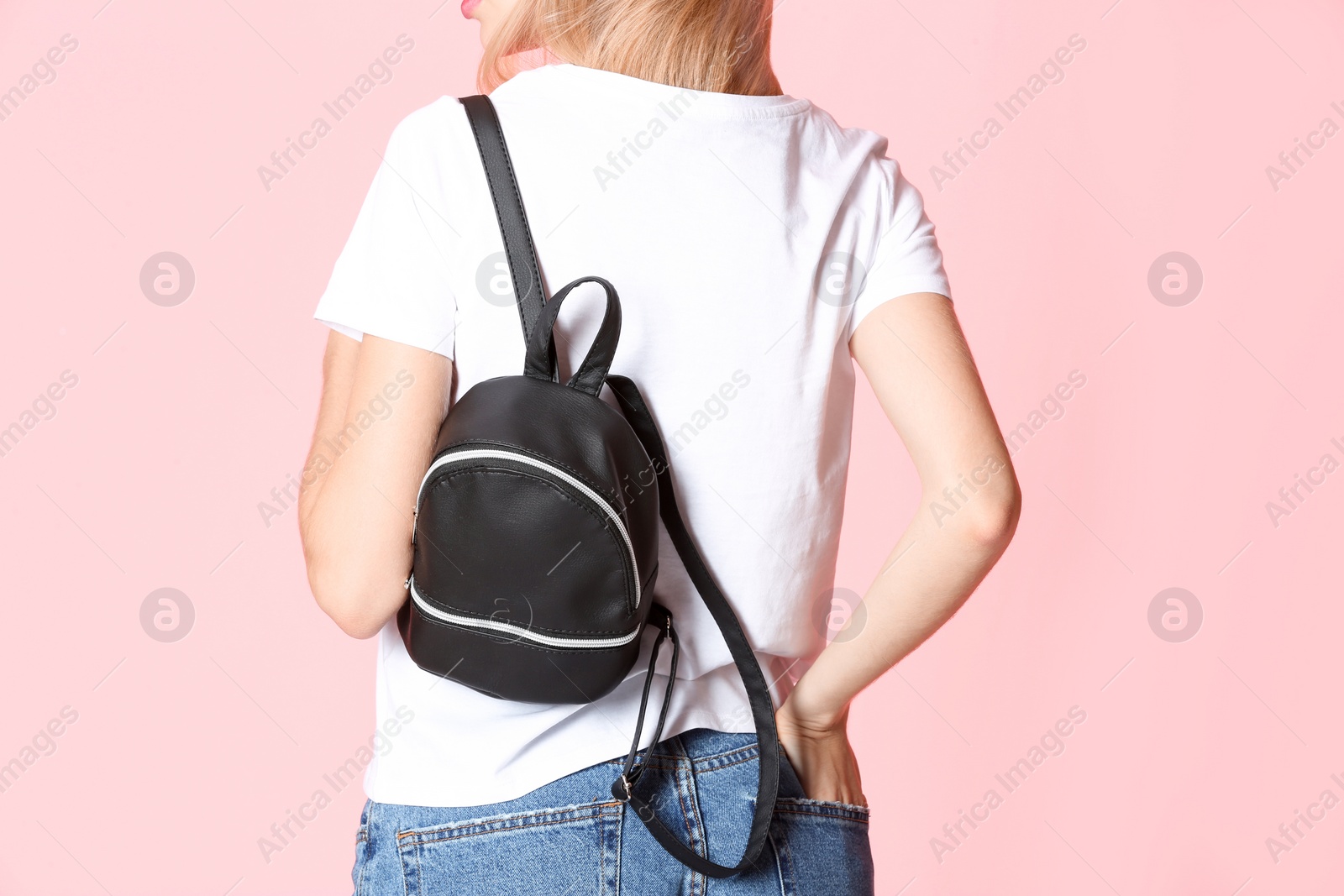 Photo of Woman with stylish backpack on color background, closeup