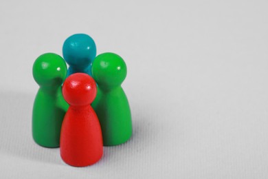 Photo of Colorful pawns on light grey background, closeup with space for text. Recruiter searching employee