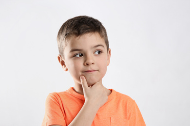 Photo of Emotional little boy in casual outfit on white background