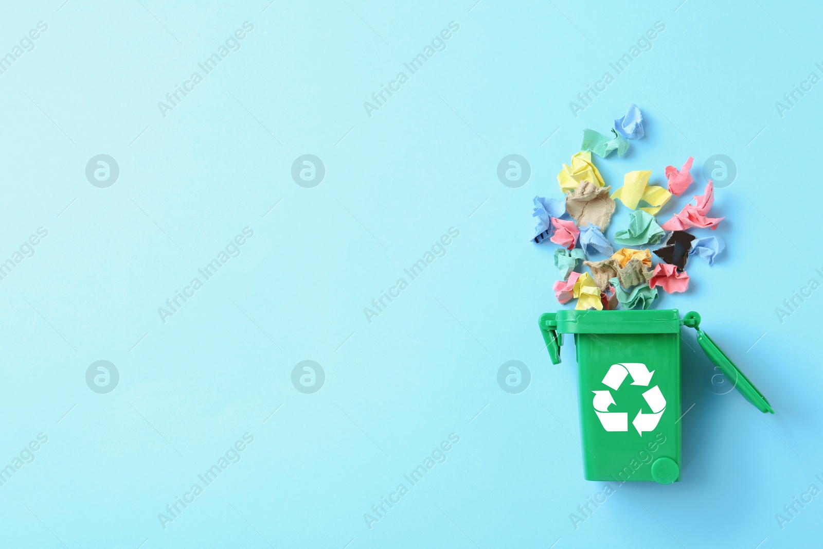Photo of Trash bin and different garbage on color background, top view with space for text. Waste recycling concept