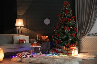 Photo of Stylish room interior with decorated Christmas tree