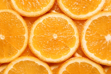 Juicy orange slices as background, top view. Citrus fruit