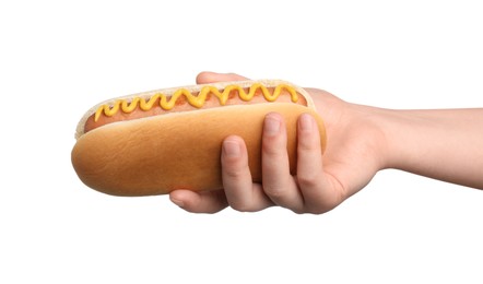 Photo of Woman holding delicious hot dog with mustard on white background, closeup