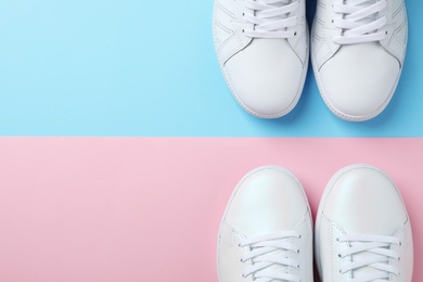 Photo of Stylish sneakers on color background, flat lay. Space for text