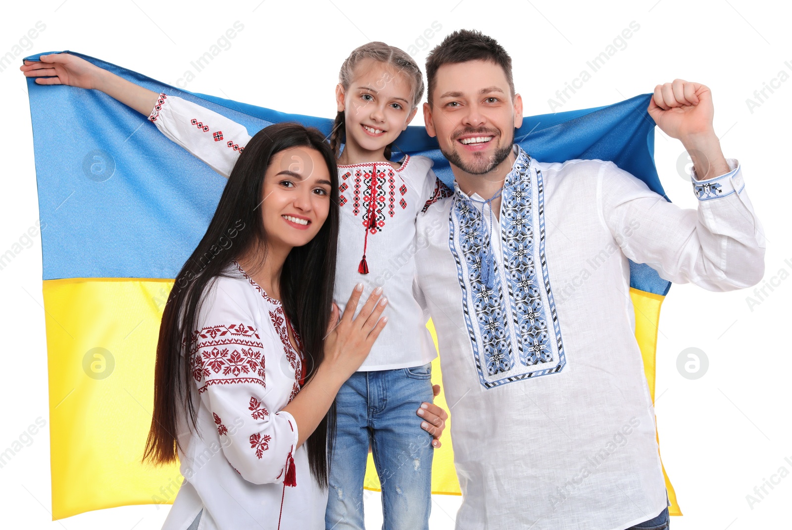 Photo of Happy family in national clothes with flag of Ukraine on white background